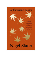 orange book cover with golden maple leaves floating down with 'a thousand feasts' in black text at the top