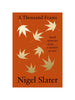 orange book cover with golden maple leaves floating down with 'a thousand feasts' in black text at the top