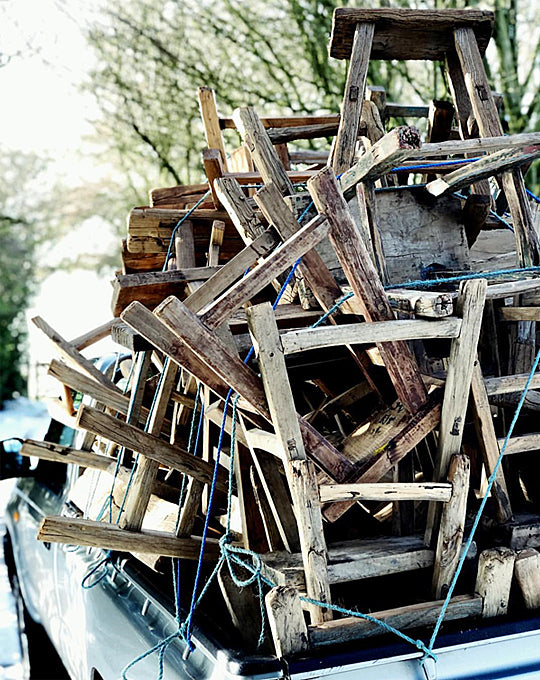 a pile of old elm stools stacked on the back of a truck