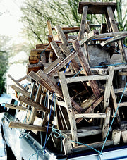 a pile of old elm stools stacked on the back of a truck