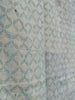 close up shot of the indian kantha quilt reverse side with pale turquise and cream pattern and rippled surface texture