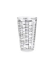Clear glass measuring cup with milliliter markings on a white background