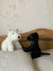 cuddly toy dogs. white fluffy scottie dog with a black nose and eyes. black short coated soft labrador.