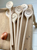 traditional round headed wooden spoons with a happy smiley face.