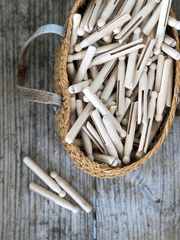 Basket of traditional, wooden dolly pegs
