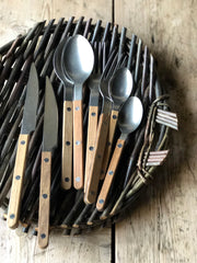  Cutlery with a  brushed gunmetal finish, made of a stainless steel and carbon alloy with a teak wood handle.