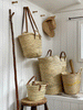 Assorted sizes of palm leaf baskets in a light, natural colour. Soft brown handles or natural coloured sisal.